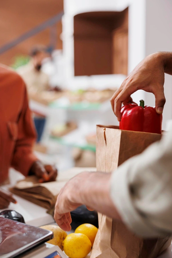 Vendor packing locally grown food bag